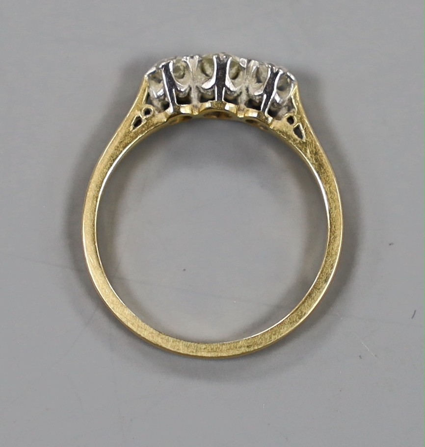 An 18ct, plat and three stone diamond set ring, size J, gross weight 2 grams.